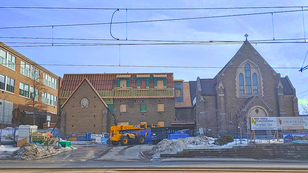 Construction work to convert the former St. Mark's Lutheran Church on King Street in Kitchener, Ontario into the St. Mark's Place housing project. The work in progress on the second storey addition above the former parish hall is prominent.